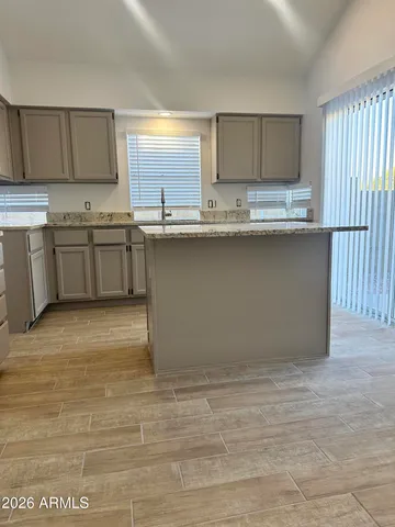 a kitchen with granite countertop a stove a sink and a granite counter tops