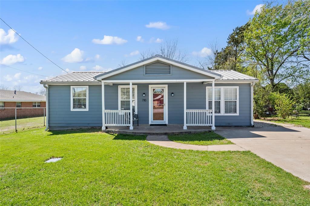 Bungalow-style house with covered porch and a metal roof