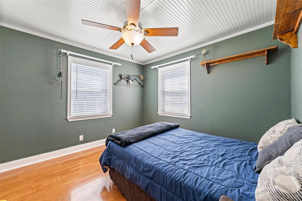 710 South Old Temple Road Lorena, TX 76655 - Photo 12 of 19 Bedroom featuring wood finished floors, ceiling fan, and ornamental molding