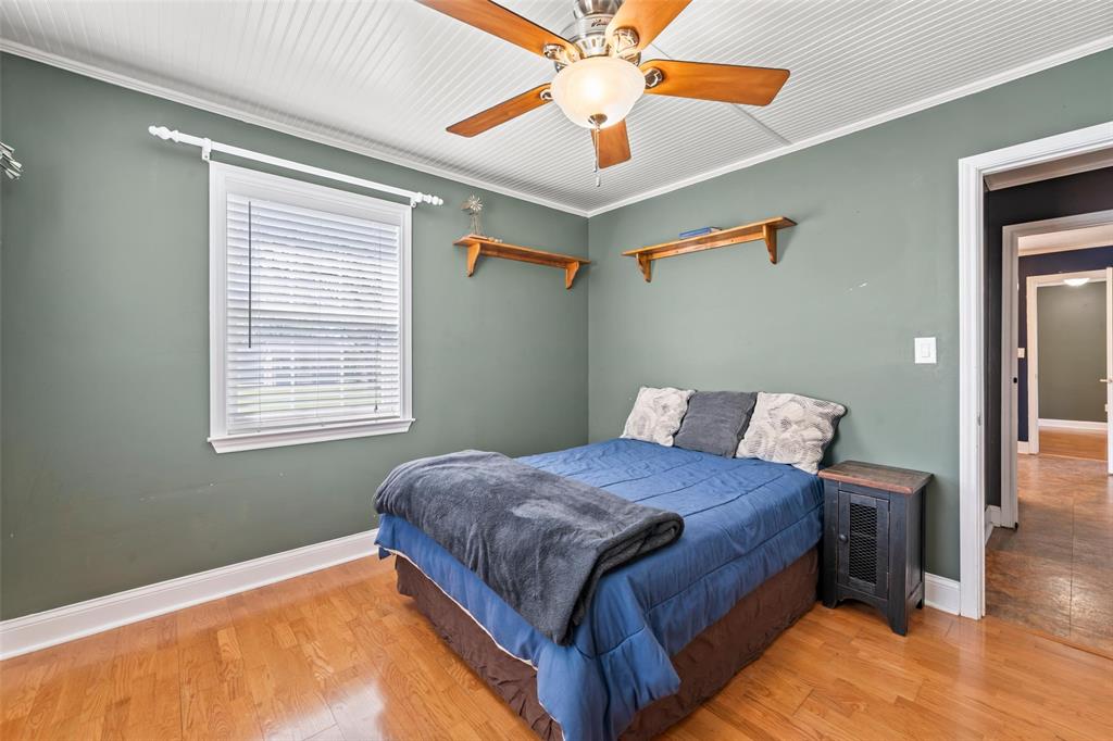 710 South Old Temple Road Lorena, TX 76655 - Photo 13 of 19 Bedroom with light wood-style floors, a ceiling fan, and ornamental molding