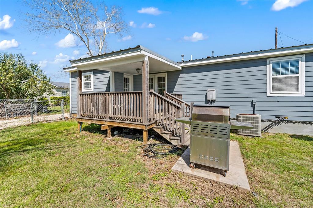 710 South Old Temple Road Lorena, TX 76655 - Photo 14 of 19 Rear view of house with a metal roof and a deck