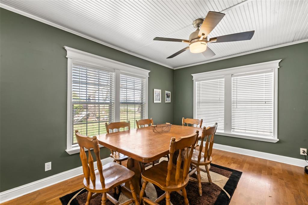 710 South Old Temple Road Lorena, TX 76655 - Photo 3 of 19 Dining area with wood-type flooring, ceiling fan, and ornamental molding