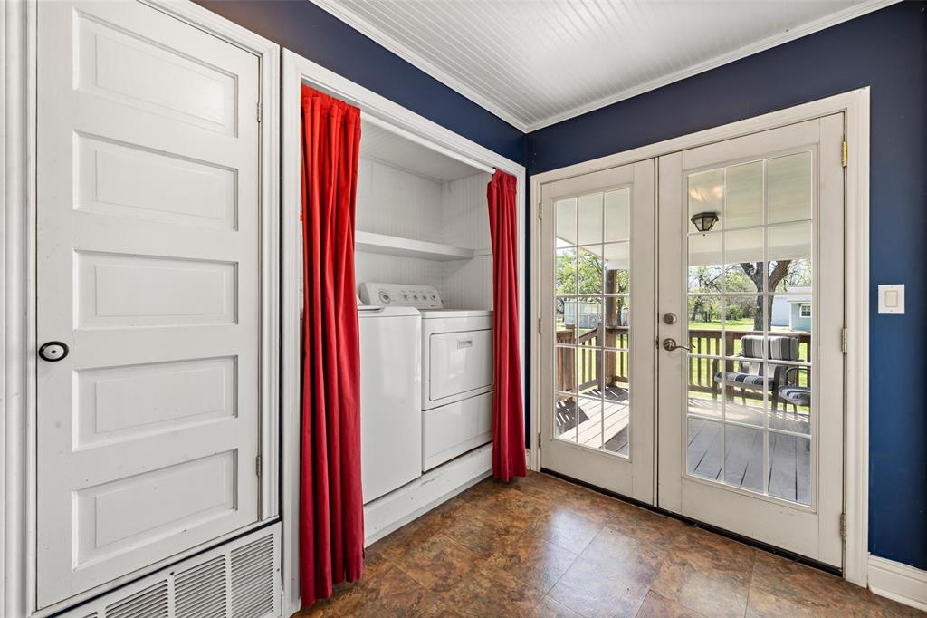 710 South Old Temple Road Lorena, TX 76655 - Photo 8 of 19 Laundry area featuring french doors, washer and dryer, ornamental molding, and stone finish flooring