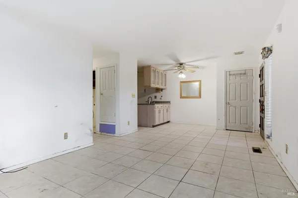 a view of a kitchen with a sink and a refrigerator