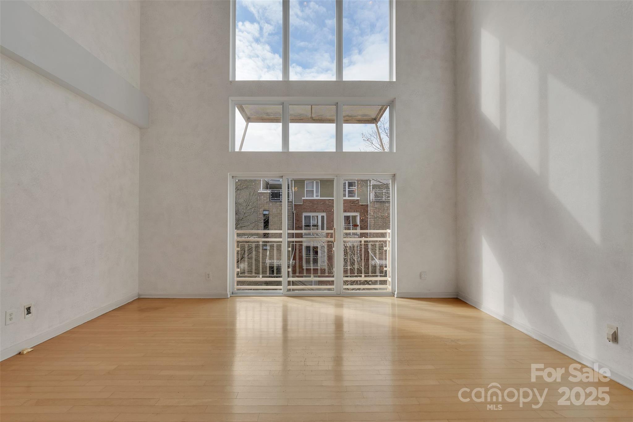 649 Raphael Place Charlotte, NC 28205 - Photo 2 of 47 an empty room with wooden floor and windows