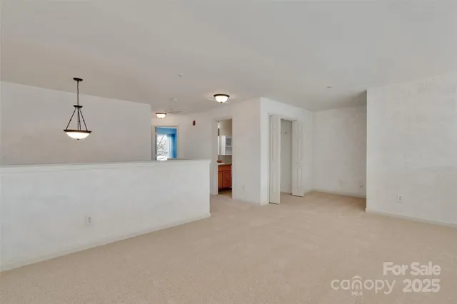 a view of an empty room and closet area