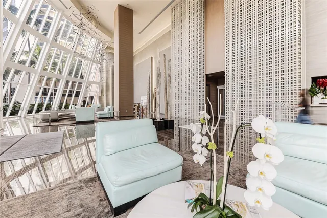 a view of a balcony with chairs and potted plant