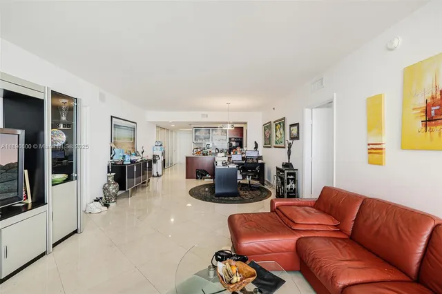 a living room with furniture flat screen tv and wall paintings
