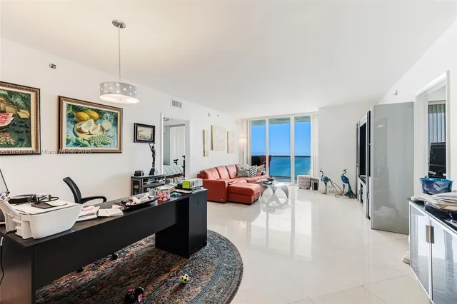 a kitchen with stainless steel appliances granite countertop a sink counter space and living room view