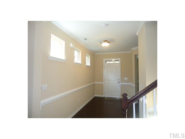 813 Wickham Ridge Road Apex, NC 27539 - Photo 13 of 25 Large open foyer! Lots of natural light, 9 ft ceilings, crown moldimg and chair rail.