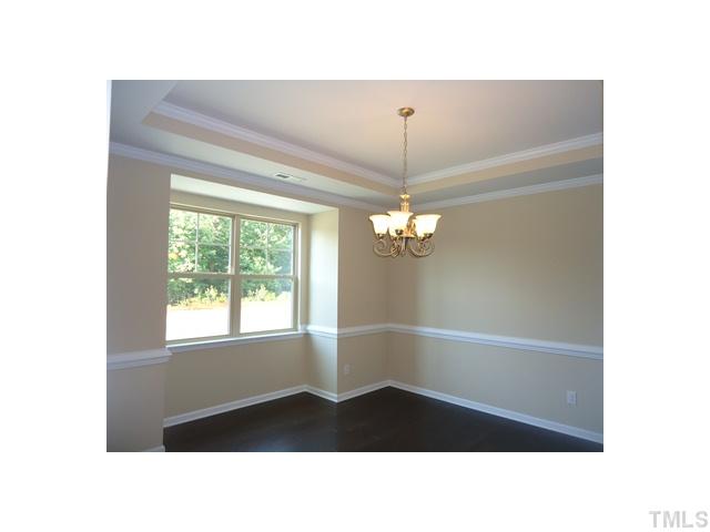 813 Wickham Ridge Road Apex, NC 27539 - Photo 10 of 25 Formal Dining Room! Hardwood floors, trey ceiling with crown, chair rail and a butlers pantry.
