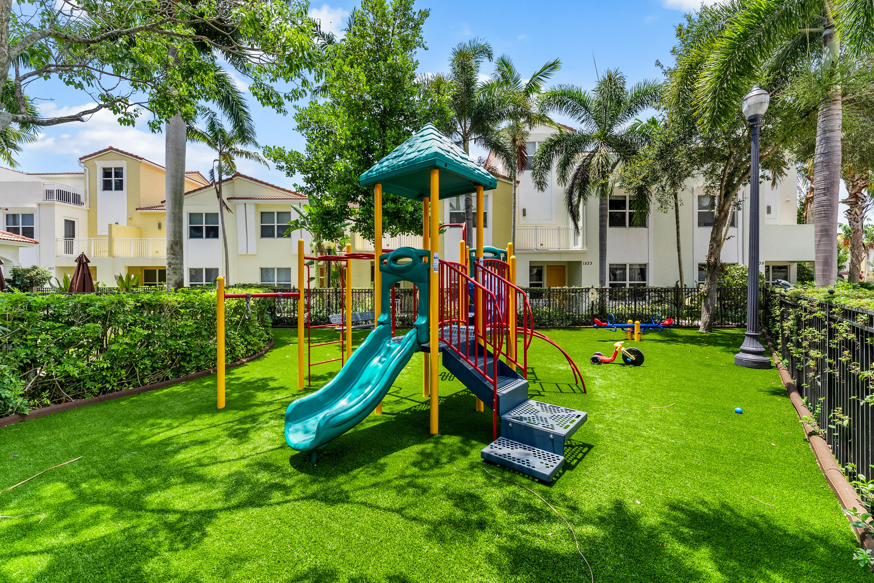 1430 Northwest 48th Lane Boca Raton, FL 33431 - Photo 52 of 54 a view of a backyard with a slide and a child swing