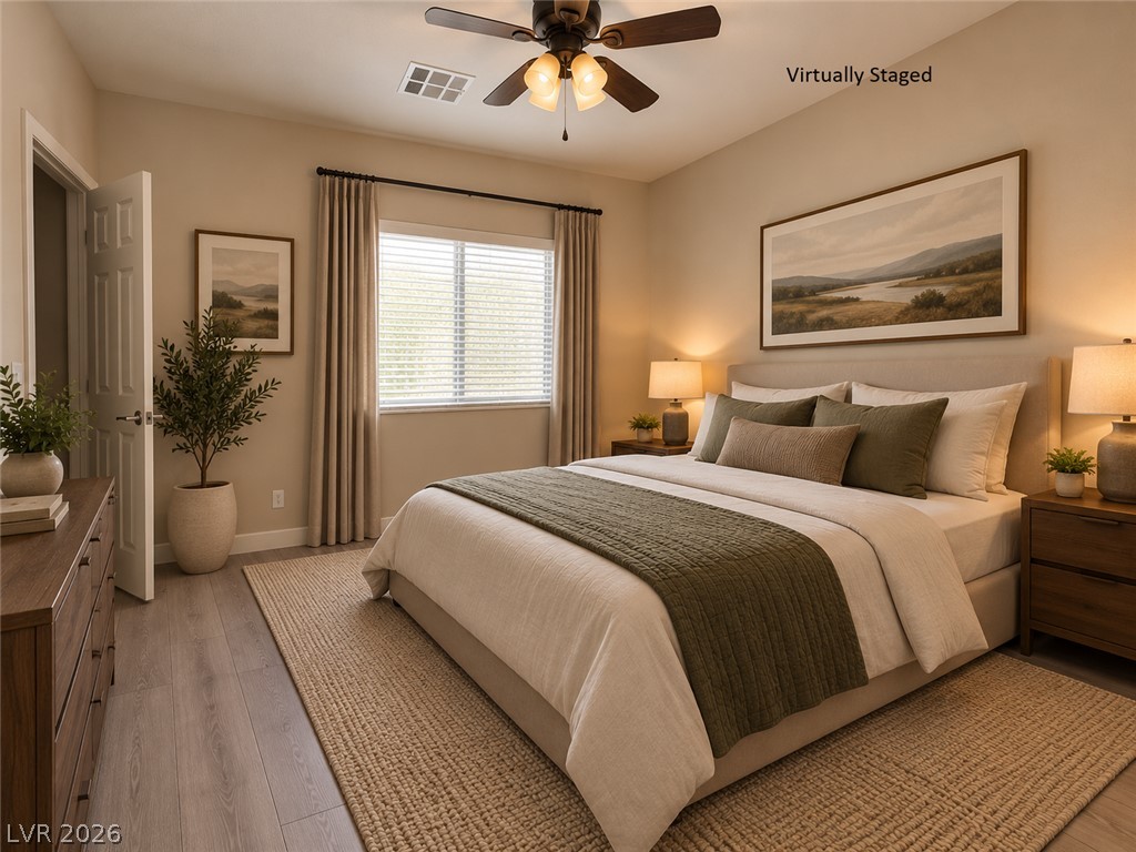 8059 Encanterra Road Las Vegas, NV 89113 - Photo 30 of 52 Smooth wood-style flooring and a large window bring warmth to this restful bedroom retreat.