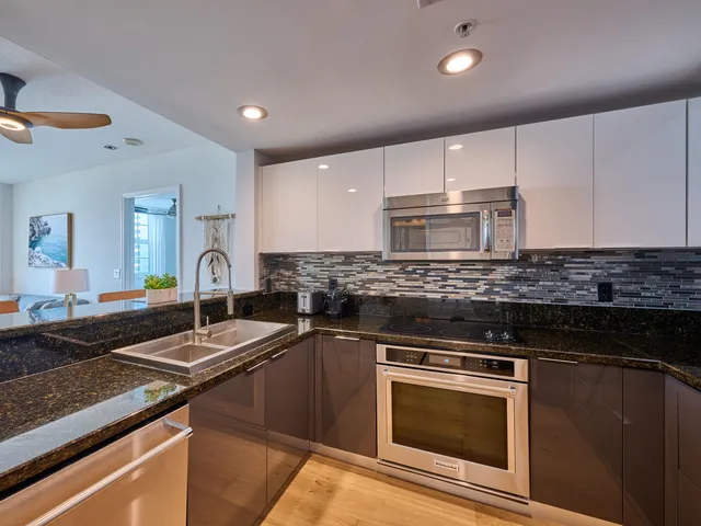 a kitchen with granite countertop a stove and a sink