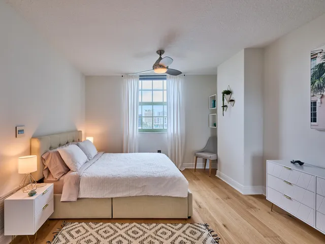 a bedroom with a bed and a lamp