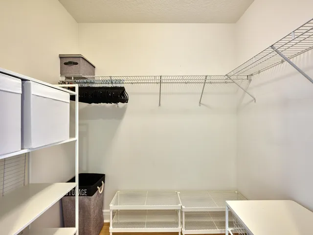a bathroom with a granite countertop double vanity sink and a mirror