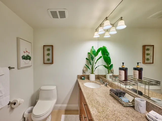 a view of swimming pool with a garden and plants