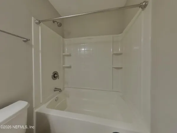 a bathroom with a bathtub and a toilet