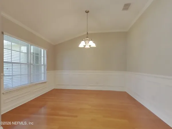a view of a room with windows and chandelier