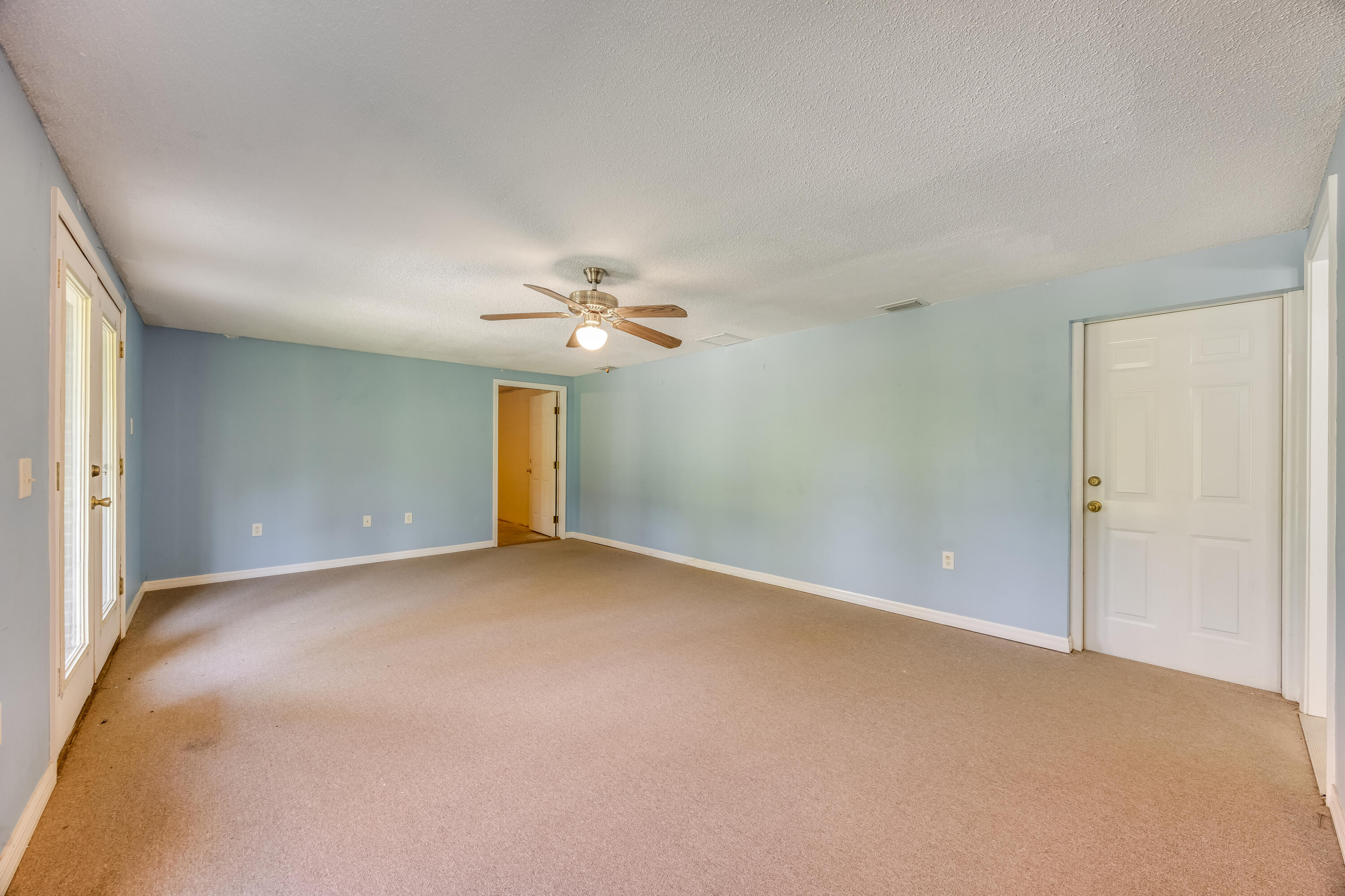 4555 Wolf Track Ridge, Unit 15 15 ACRES Crestview, FL 32539 - Photo 39 of 65 a view of an empty room with a chandelier fan