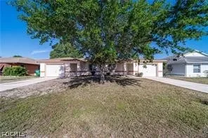 front view of a house with a tree
