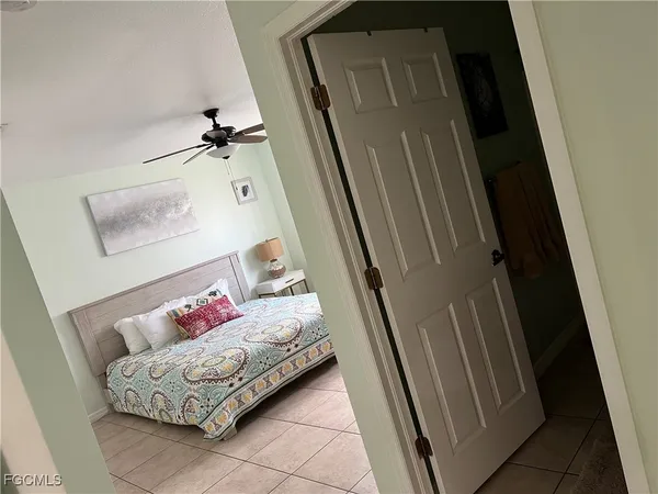 a living room with furniture and a baby crib