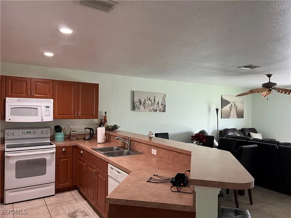 a kitchen with a sink refrigerator and cabinets