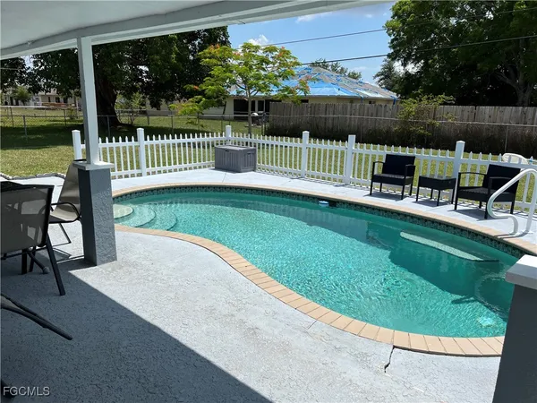 a view of backyard with deck and outdoor seating