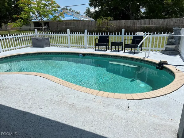 a view of a house with a swimming pool and porch