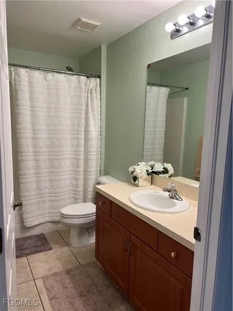 a bathroom with a double vanity sink toilet and shower