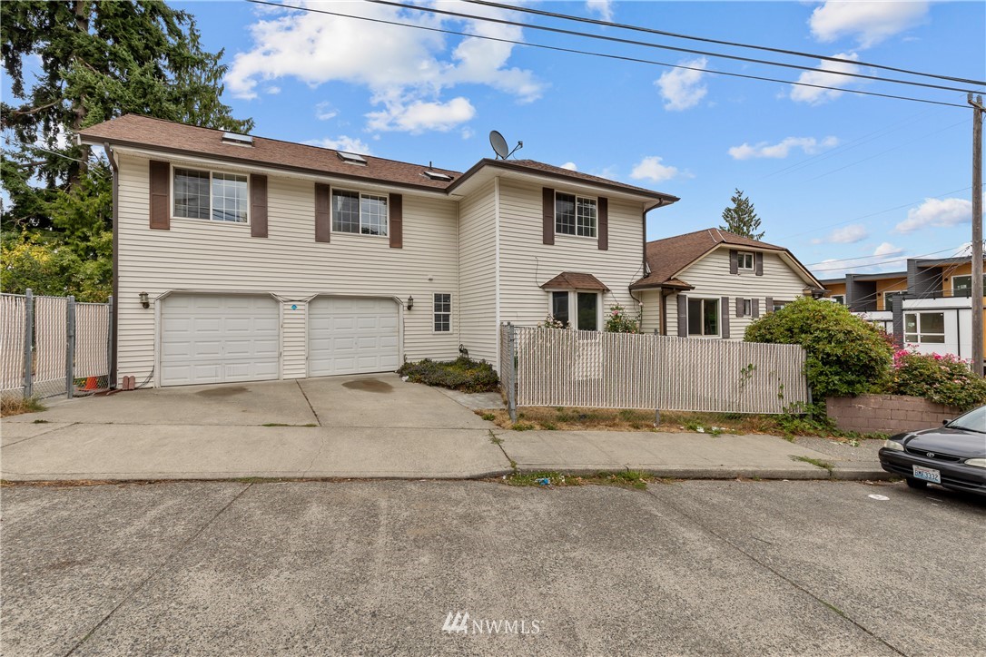 5069 Renton Avenue South Seattle, WA 98118 - Photo 2 of 40 a front view of a house with a yard and garage