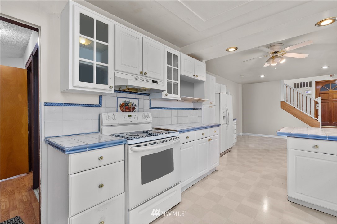 5069 Renton Avenue South Seattle, WA 98118 - Photo 13 of 40 a kitchen with stainless steel appliances granite countertop a stove and a sink