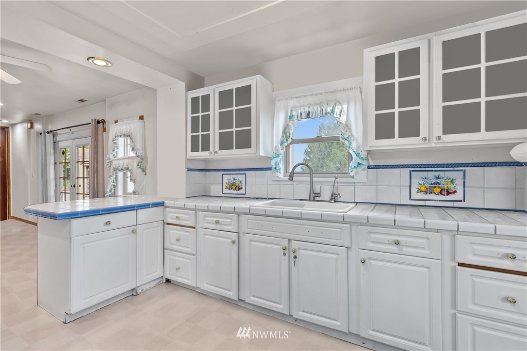5069 Renton Avenue South Seattle, WA 98118 - Photo 14 of 40 a kitchen with cabinets and window