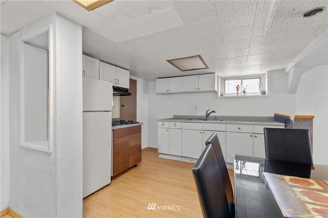 5069 Renton Avenue South Seattle, WA 98118 - Photo 28 of 40 a kitchen with a sink refrigerator and cabinets