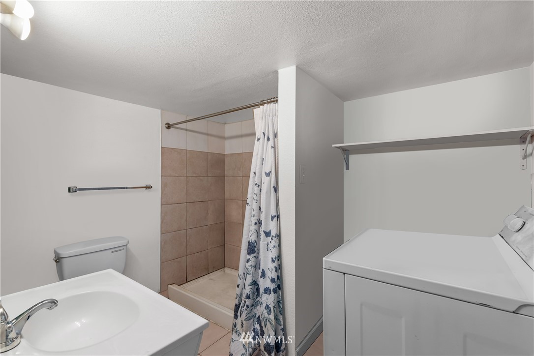 5069 Renton Avenue South Seattle, WA 98118 - Photo 35 of 40 a bathroom with a shower a toilet and sink