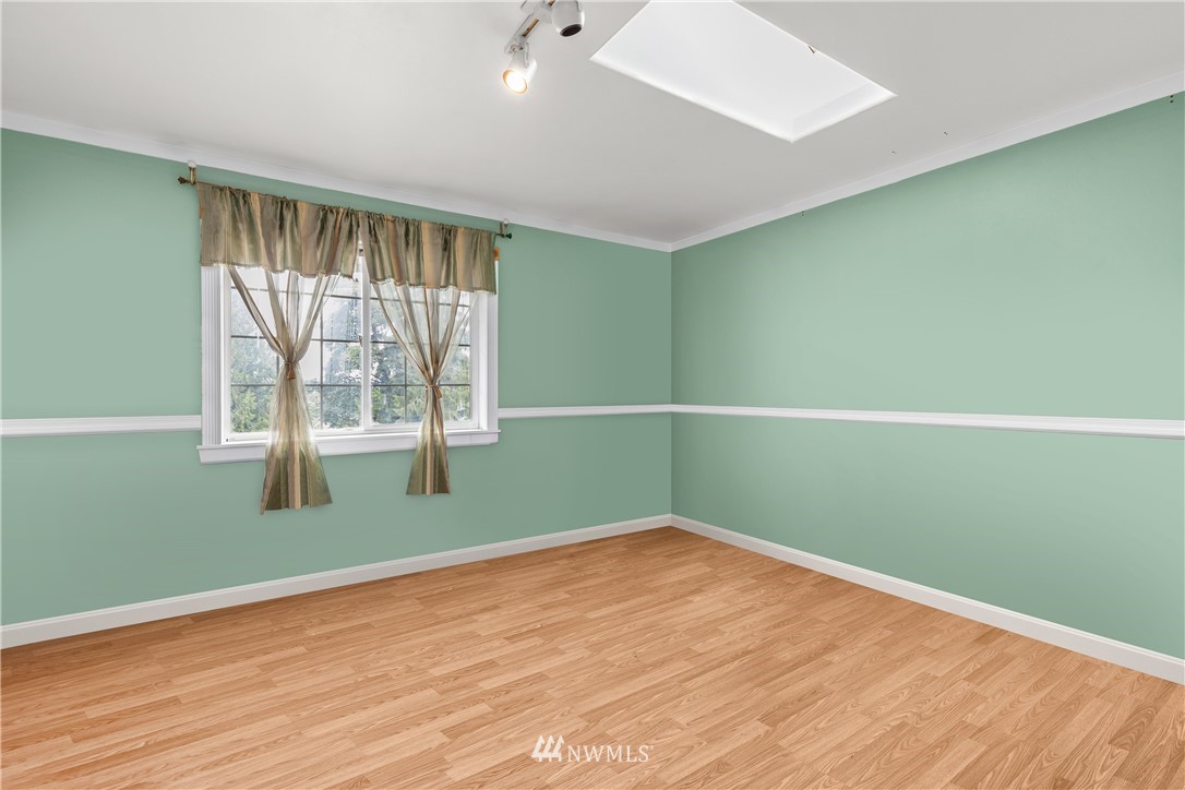5069 Renton Avenue South Seattle, WA 98118 - Photo 7 of 40 an empty room with wooden floor and windows