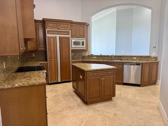 a stove top oven sitting inside of a kitchen