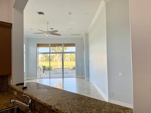 a kitchen with granite countertop a sink stove and cabinets