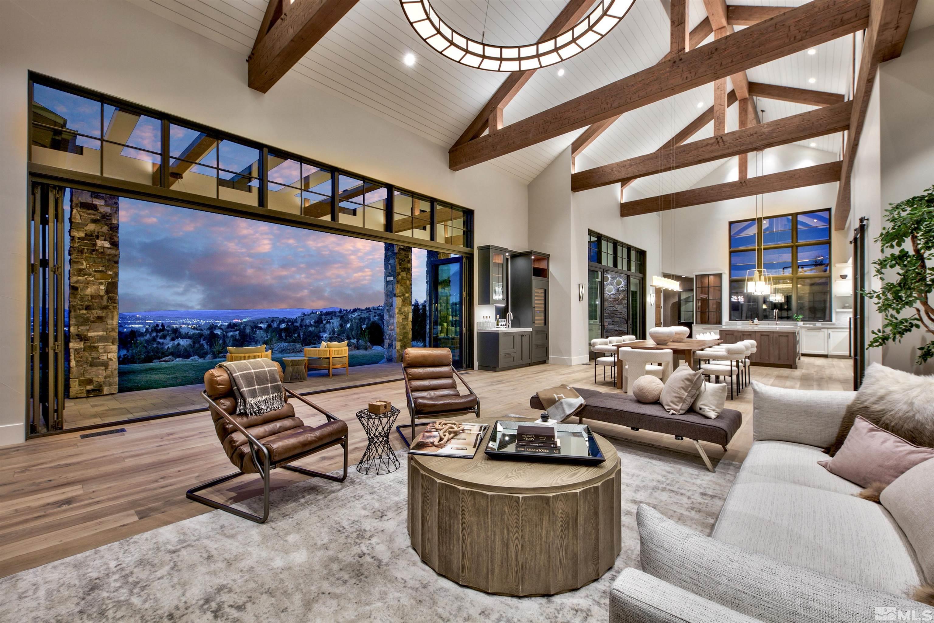 a living room with furniture a floor to ceiling windows and a flat screen tv