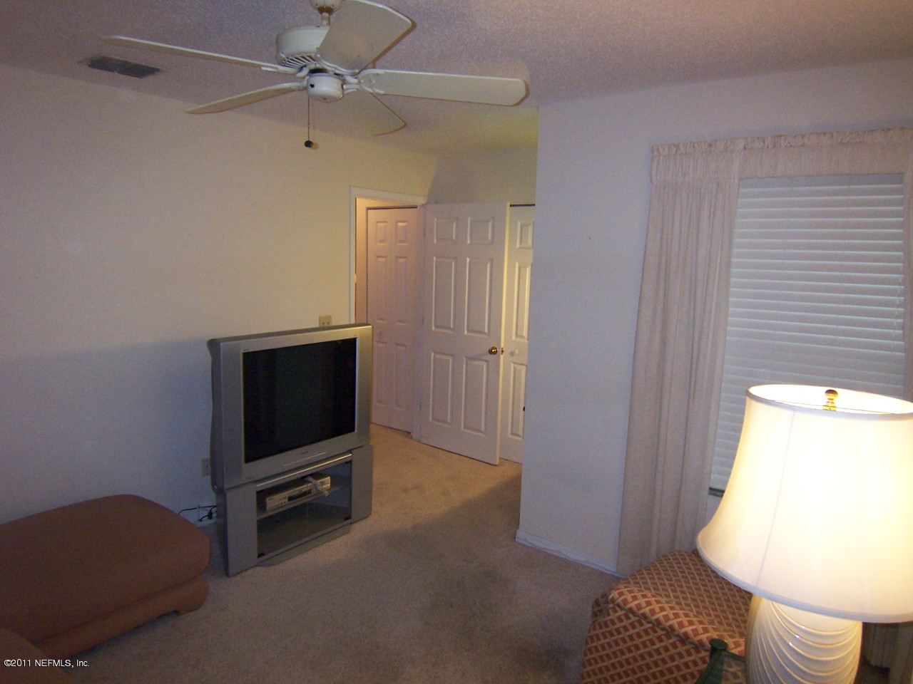 1488 Marsh Rabbit Way Fleming Island, FL 32003 - Photo 11 of 17 a living room with furniture and a flat screen tv