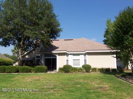 1488 Marsh Rabbit Way Fleming Island, FL 32003 - Photo 15 of 17 a front view of a house with a yard