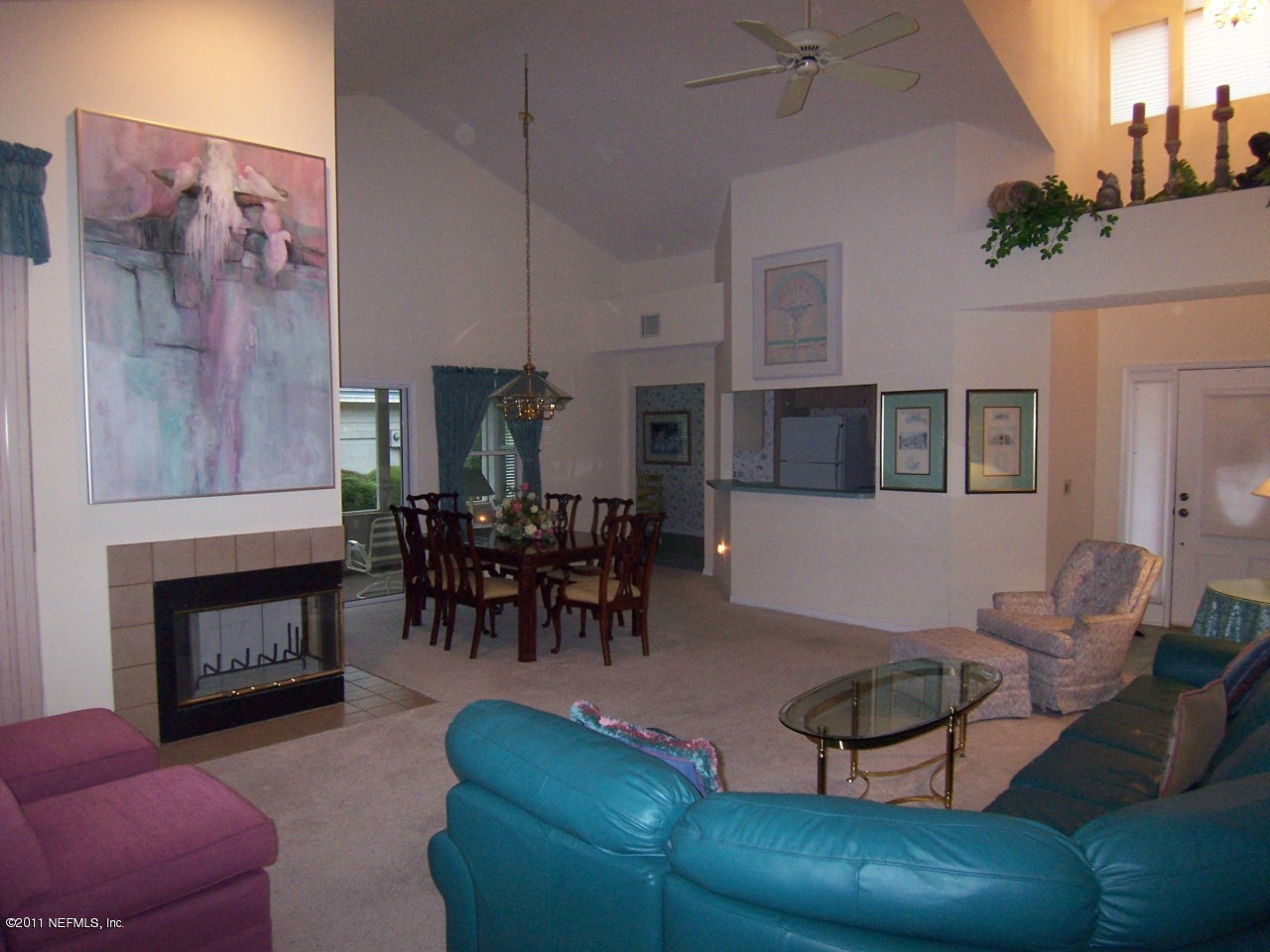 1488 Marsh Rabbit Way Fleming Island, FL 32003 - Photo 2 of 17 a living room with furniture and a fireplace