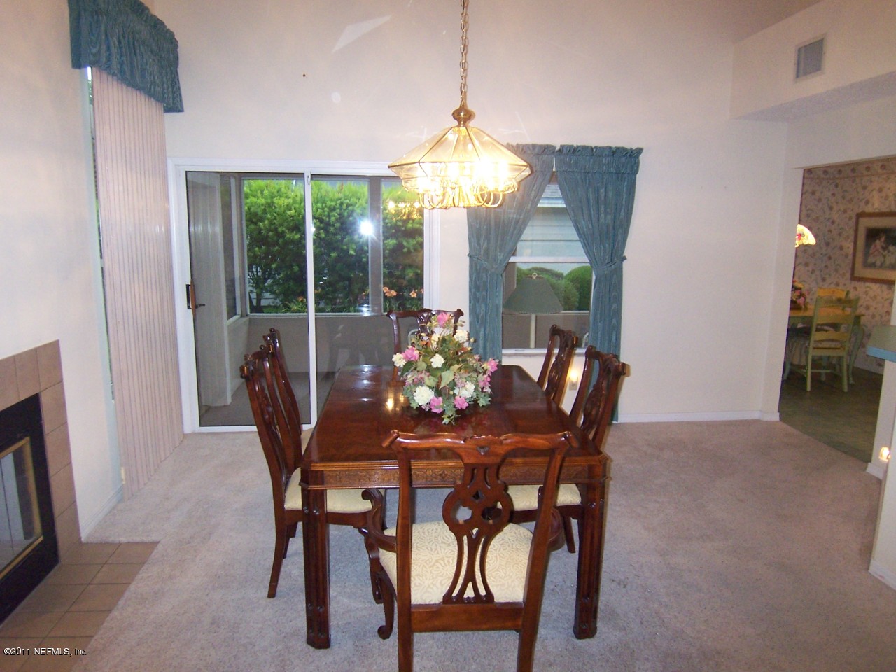 1488 Marsh Rabbit Way Fleming Island, FL 32003 - Photo 4 of 17 a dining room with furniture a chandelier and window