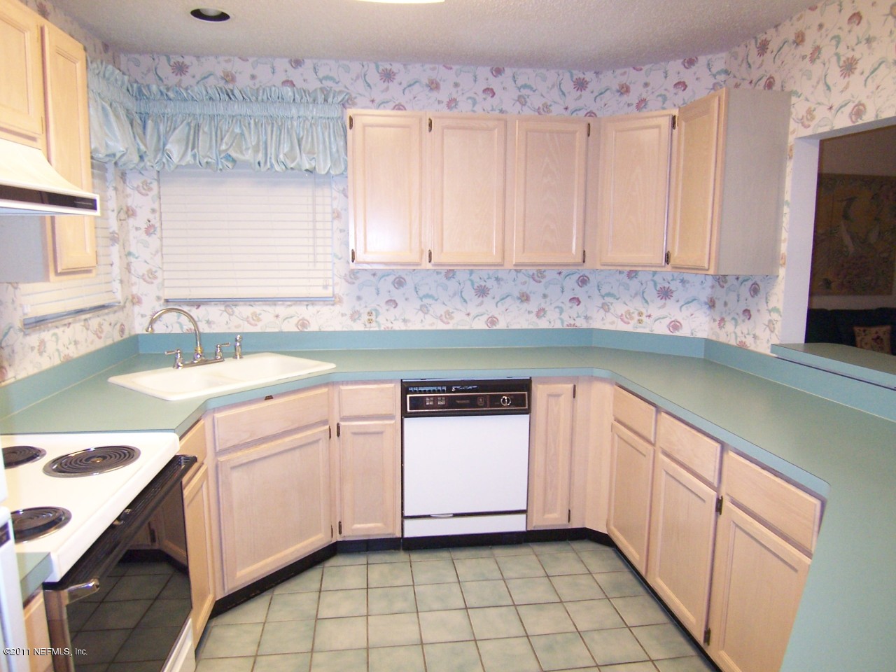 1488 Marsh Rabbit Way Fleming Island, FL 32003 - Photo 5 of 17 a kitchen with a sink and a stove top oven