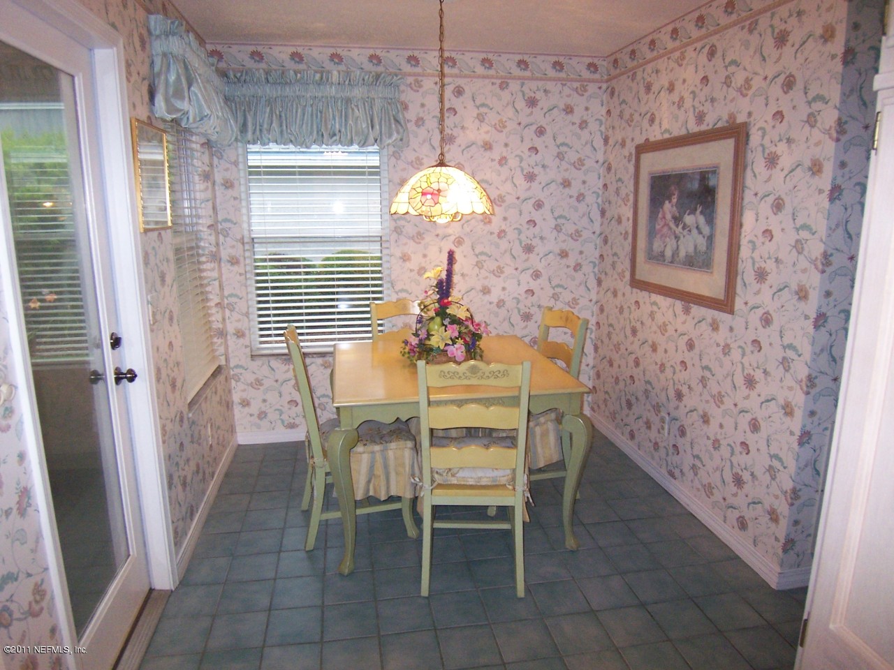 1488 Marsh Rabbit Way Fleming Island, FL 32003 - Photo 6 of 17 a dining room with furniture and chandelier