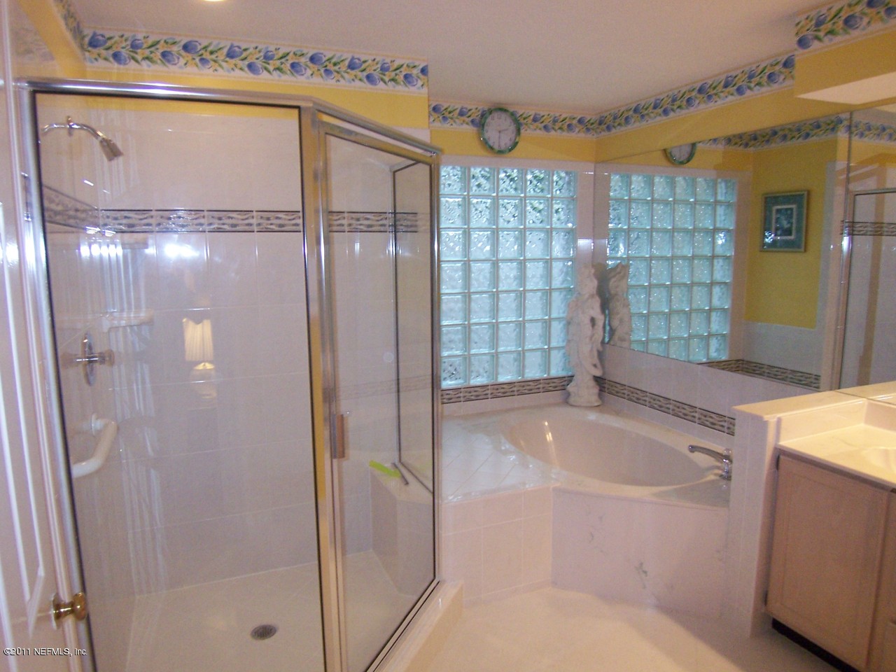 1488 Marsh Rabbit Way Fleming Island, FL 32003 - Photo 8 of 17 a bathroom with a tub and shower