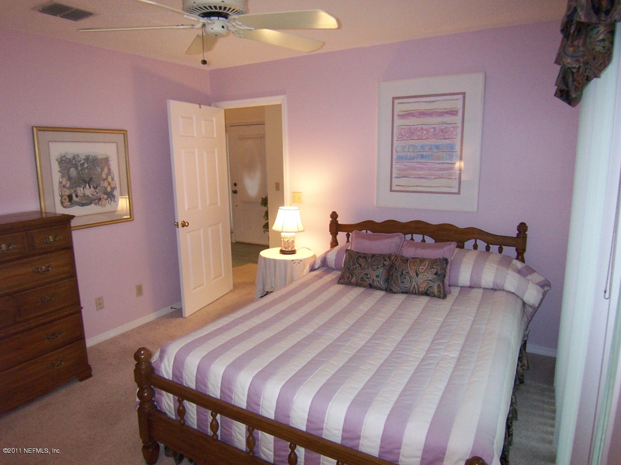 1488 Marsh Rabbit Way Fleming Island, FL 32003 - Photo 10 of 17 a bedroom with a bed and a chandelier