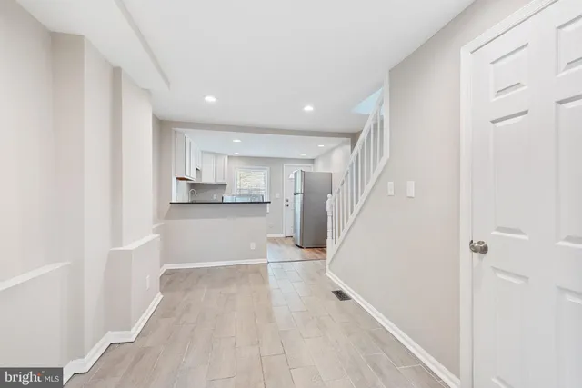 a view of a kitchen with wooden floor and electronic appliances