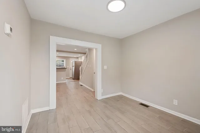 a view of a room with wooden floor and a sink