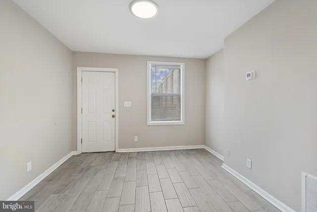 a view of room with window and hardwood floor